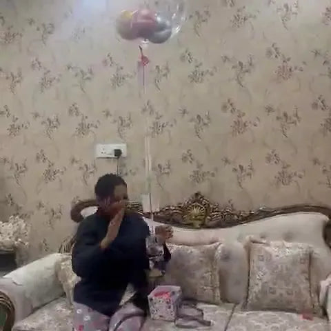 Box with floating balloon